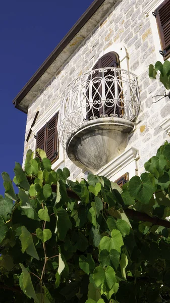 Small balcony of stone sea house - Rose Village, Lustica peninsula, Kotor Bay, Montenegro, Europe.