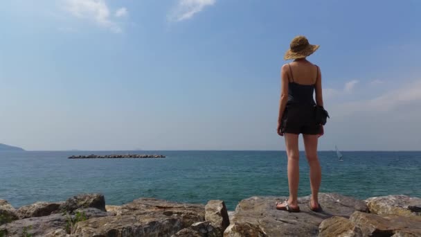 Young Woman watching windsurfers — Stock Video