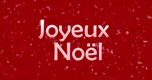 Feliz texto de Navidad en francés "Joyeux Noel" se convierte en polvo de abajo sobre fondo rojo animado — Vídeo de stock