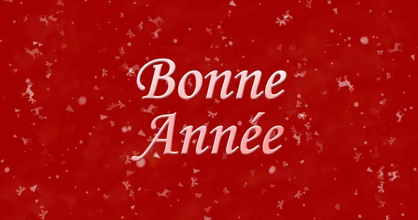 Счастливый Новый год текст на французском языке «Bonne annee» на красном фоне — стоковое фото