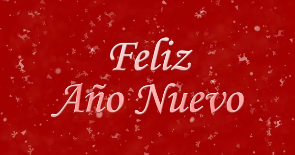 Šťastný nový rok text ve španělštině "Feliz ano nuevo" na červeném pozadí — Stock fotografie