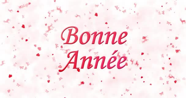 Щасливого нового року текст по-французьки "Bonne annee" утворено від пилу і перетворюється на пил по горизонталі на білому тлі анімовані — стокове відео