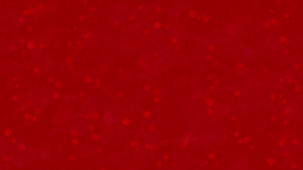 Feliz día de San Valentín texto en francés "Bonne Saint Valentin" formado a partir de polvo y se convierte en polvo horizontalmentesobre fondo rojo — Vídeo de stock