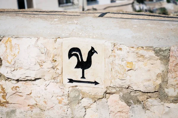 Arrow pointer with black cock on the way to Church of Saint Peter in Gallicantu, located on Mount Zion, Jerusalem, Israel