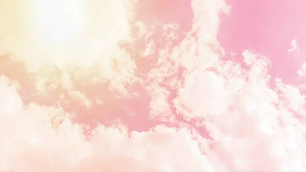 Sunny orange pink sky background. Beautiful warm sky with clouds. Toned photo, 16:9 panoramic format