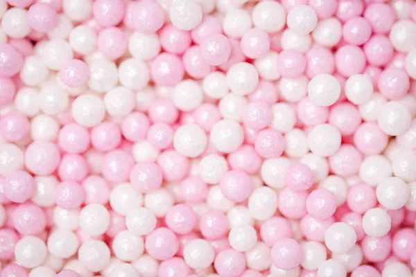 Pastel pink and white background. Sweet sugar balls. Sprinkles sugar texture. Bokeh, blurred background — Stock Photo, Image