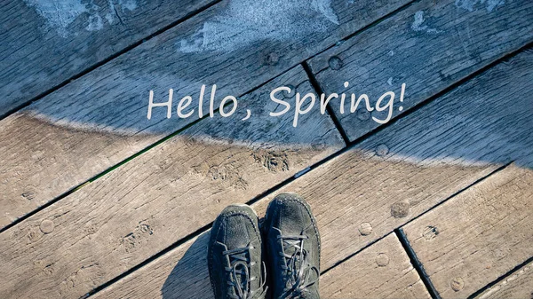 Hello Spring words. Concept of transition from winter to spring. Spring is coming. Warm and cold, frost and sun. 16:9