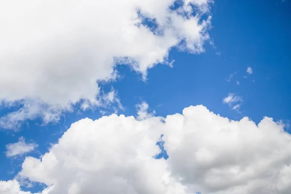 Blue sky background. Blue sky with fluffy white clouds. Copy space — ストック写真