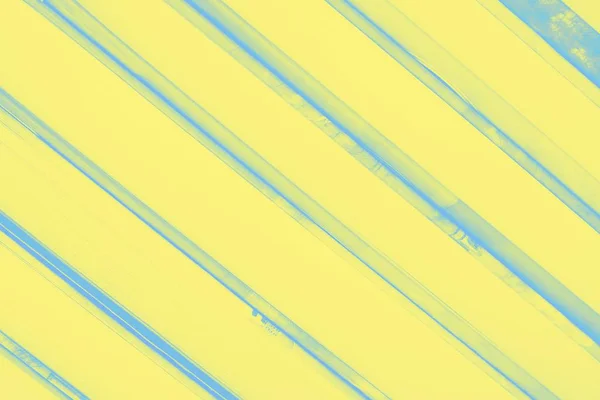 Yellow background with diagonal blue frayed stripes — ストック写真