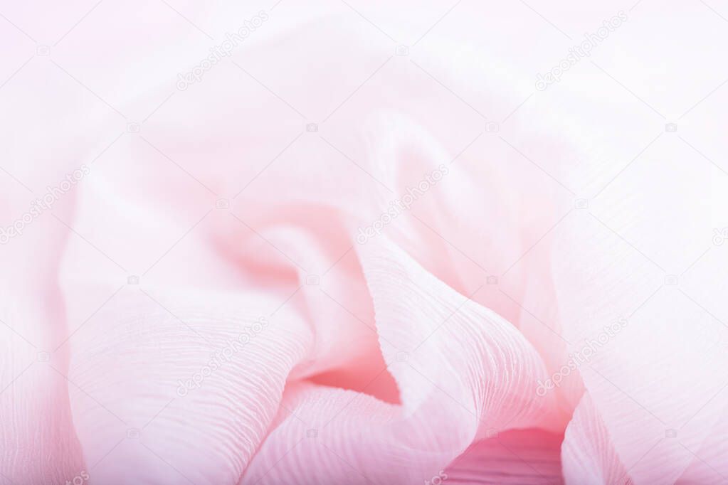 Pale light pink corrugated flowing silk fabric background