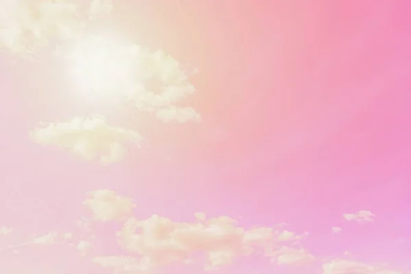 Sunny pink sky background. Beautiful warm sky with clouds, toned