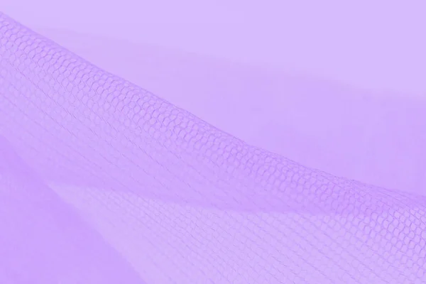 Light small mesh fabric on violet background, shades of violet