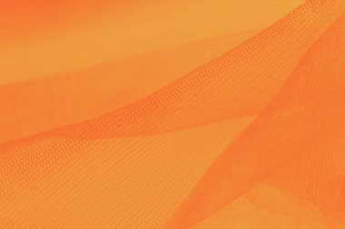 Turuncu arka planda küçük örgü kumaş. Turuncu tonlarda, sıcak tonlarda.