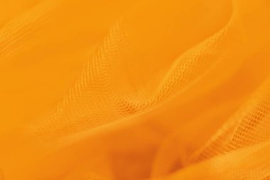 Turuncu arka planda küçük örgü kumaş. Turuncu tonlarda, sıcak tonlarda.
