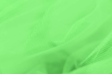 Açık yeşil arkaplanda küçük ağ kumaşı