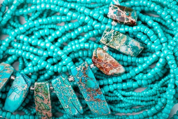 Beautiful turquoise stone background. Turquoise necklace with beautiful streaked beads