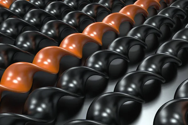 Spiralstäbe aus schwarzem und orangefarbenem Kunststoff auf schwarzem Hintergrund — Stockfoto