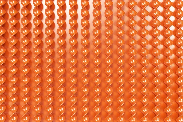 Orange Kunststoff-Spiralstäbe auf orangefarbenem Hintergrund — Stockfoto