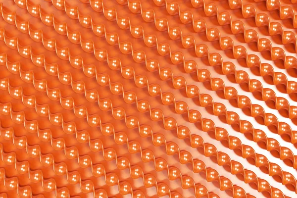 Pomarańczowy plastikowe spiralne ramiona na pomarańczowym tle — Zdjęcie stockowe