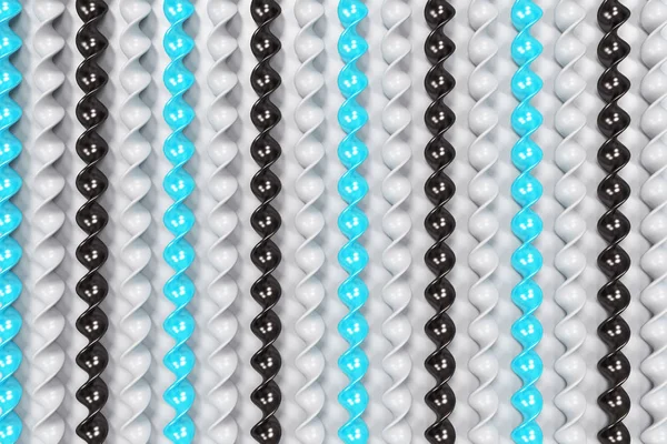 Preto, branco e azul plástico espiral paus no fundo branco — Fotografia de Stock