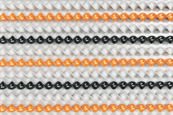 Black, white and orange plastic spiral sticks on white backgroun