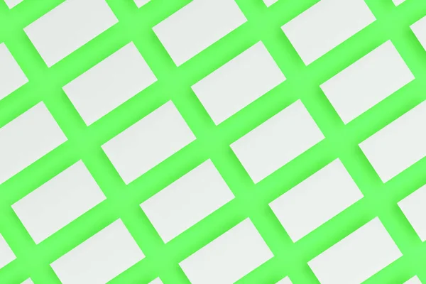 Tarjetas de visita blancas en blanco maqueta sobre fondo verde —  Fotos de Stock