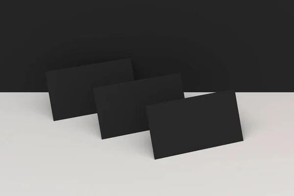 Black blank business cards mock-up on black and white background — Stock Photo, Image