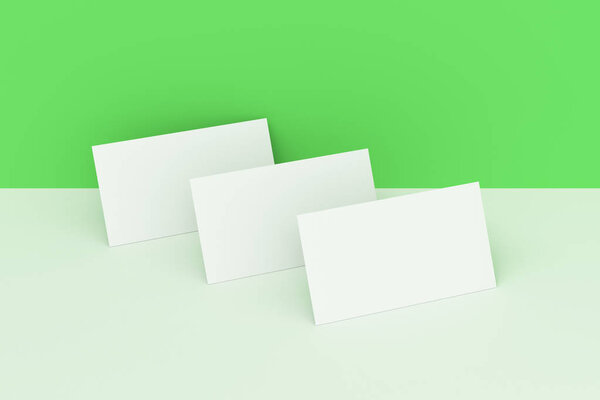 White blank business cards mock-up on green and white background