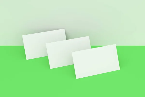 White blank business cards mock-up on green and white background
