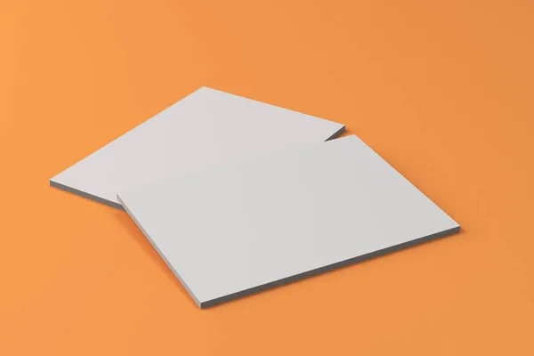 Twee lege witte gesloten brochure mock-up op oranje achtergrond — Stockfoto