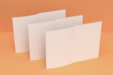 Üç boş beyaz açık broşür mock-up turuncu zemin üzerine