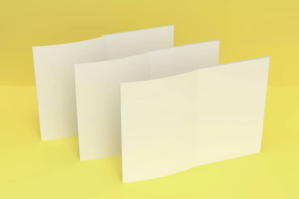 Makieta trzy puste biały broszura otwarte na żółtym tle — Zdjęcie stockowe