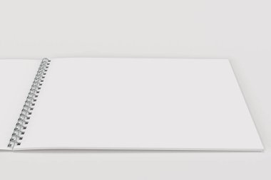Açık boş beyaz defter ile metal sarmal üzerinde beyaz backg bağlı