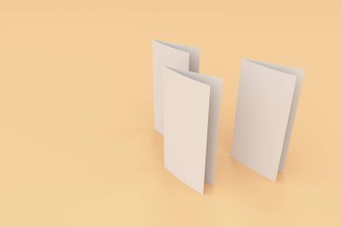 Boş beyaz iki kat broşürü mockup turuncu zemin üzerine