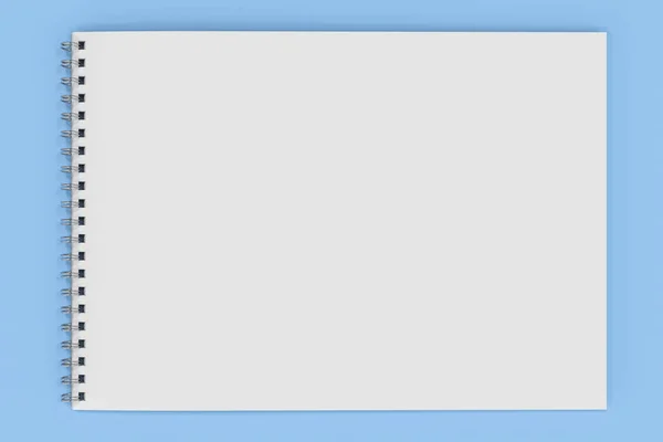 Порожній білий блокнот з металевою спіраллю, прив'язаною на синьому фоні — стокове фото