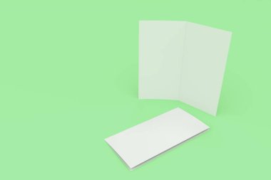 Boş beyaz iki kat broşürü mockup yeşil zemin üzerine