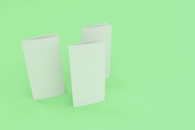 Boş beyaz iki kat broşürü mockup yeşil zemin üzerine