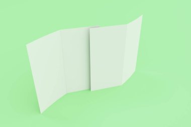 Boş beyaz iki kat broşürü mockup yeşil zemin üzerine