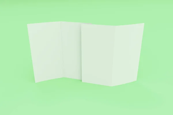 Folleto blanco en blanco de dos pliegues maqueta sobre fondo verde —  Fotos de Stock