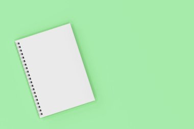 Yeşil arka plan üzerinde bağlı kapalı defter spiral