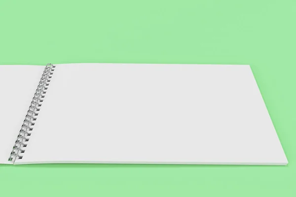 Notebook branco em branco aberto com espiral de metal encadernado em backg verde — Fotografia de Stock