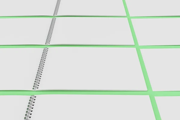 Белый блокнот с металлической спиралью на зеленом фоне — стоковое фото
