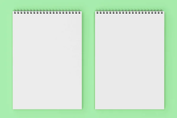 空白与金属螺旋装订在绿色背景上的白色笔记本 — 图库照片