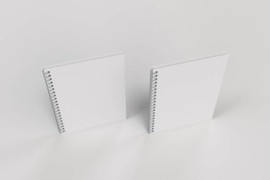 Beyaz arka plan üzerinde iki defter spiral ile bağlı