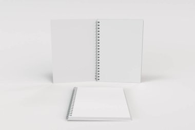 Beyaz arka plan üzerinde iki defter spiral ile bağlı