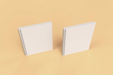 Turuncu zemin üzerine iki defter spiral ile bağlı