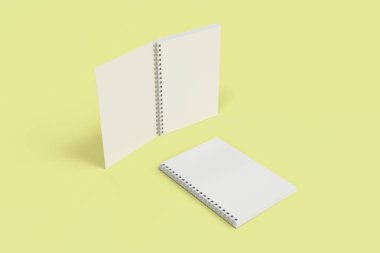 Sarı arka plan üzerinde iki defter spiral ile bağlı