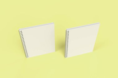 Sarı arka plan üzerinde iki defter spiral ile bağlı