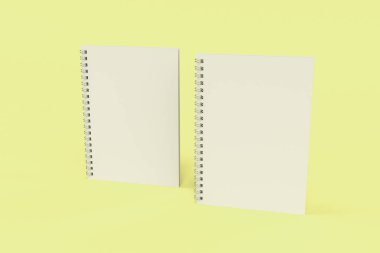 Sarı arka plan üzerinde iki defter spiral ile bağlı