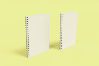 Sarı arka plan üzerinde iki defter spiral ile bağlı